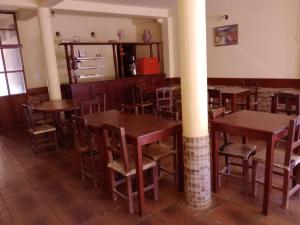 a dining room with wooden tables and chairs at MiskyPacha in Purmamarca