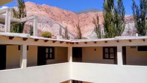 a building with a mountain in the background at MiskyPacha in Purmamarca