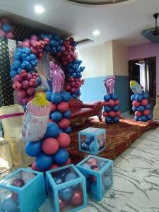a balloon arch in a room with blue and pink balloons at Hotel Biswal Inn in Cuttack