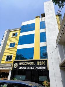 a building with a sign in front of it at Hotel Biswal Inn in Cuttack +15 photos