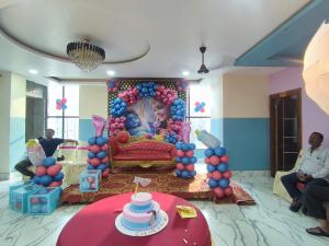 a birthday party with a little girl sitting on a throne at Hotel Biswal Inn in Cuttack