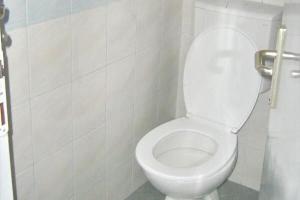 a bathroom with a white toilet in a stall at Karavan AIDA in Živogošće +54 photos