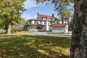 a large white house with a large yard at The Mulburn Inn in Bethlehem