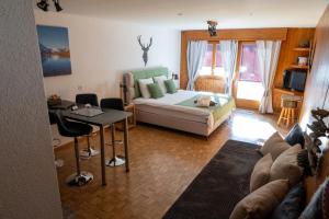 a living room with a couch and a table at Le Vieux Valais in Ovronnaz
