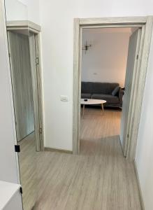 a view of a living room with a couch and a mirror at Apartament Karim in Drobeta-Turnu Severin +1 photo