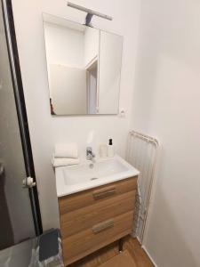 a bathroom with a sink and a mirror at L'Éclat du Miroir - AbsoluteHome in Croix