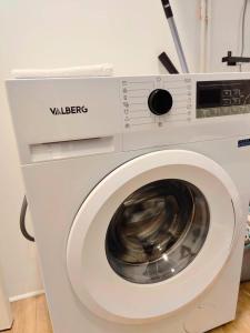 a white washing machine in a room at L'Éclat du Miroir - AbsoluteHome in Croix