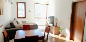 a living room with a couch and a table at Mountain View Apartment Bansko in Bansko