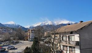 a view of snow covered mountains from a building at Mountain View Apartment Bansko in Bansko