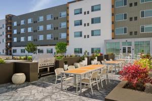 a group of tables and chairs in front of a building at Element by Marriott Pooler Savannah Airport in Savannah