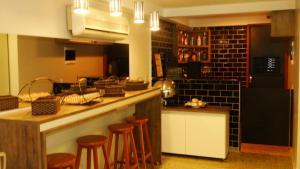 a kitchen with a counter and some stools in it at Hostel Pontal do Duque in Rio de Janeiro