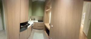 a small kitchen with wooden cabinets and a sink at Bergblick in Katzbach