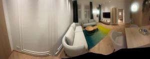 a bathroom with a couch and a television in it at Bergblick in Katzbach