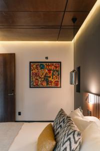 a picture hanging on a wall above a bed at Hotel Agua de Plata in San Luis Potosí +27 photos