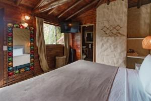 a bedroom with a bed and a mirror at Mansión by Bernalo Hotels in Guatapé +52 photos