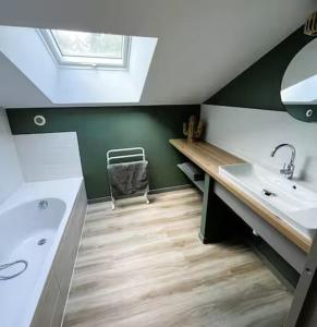 a bathroom with a sink and a mirror at Le chai de Peyssard, piscine chauffée. in Château-lʼÉvêque