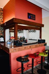 a bar with colorful stools in a restaurant at The Franklyn Hotel B&B in Blackpool