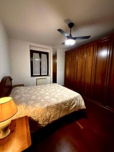 a bedroom with a bed and a ceiling fan at Il sentiero per Assisi in Bastia Umbra