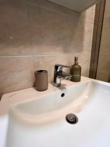 a bathroom sink with a soap dispenser on it at Il sentiero per Assisi in Bastia Umbra