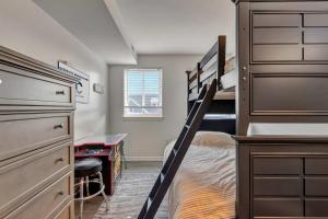 a bedroom with two bunk beds and a desk at Tiburon 5B in Ocean City