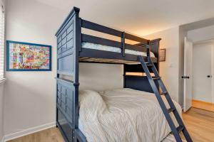 a bedroom with a bunk bed with a ladder at Tiburon 5B in Ocean City