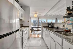 a kitchen with white cabinets and a large sink at Tiburon 5B in Ocean City