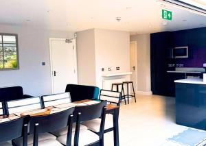 a dining room with a table and chairs at The Lockside By Allsquare Stays 5BDR Heathrow M4 M25 M3 in Staines +17 photos