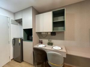 a kitchen with a counter with two sinks and a refrigerator at Casa Dune in Pune