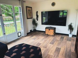a living room with a large flat screen tv at Les Hirondells in Limanton