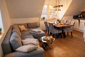 a living room with a couch and a table at Moderne Wohnung mit Privatpool in Büsum