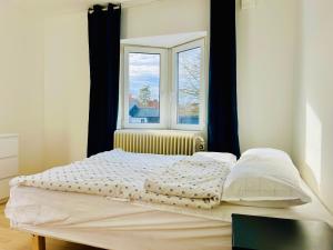 a bed in a room with a window at COZY ROOM in Helsingborg in Helsingborg