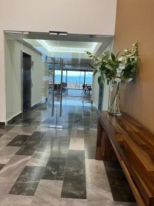 a living room with a vase of flowers on a counter at Executive Loft - Gym - Home Office - Zibatá in La Cañada +50 photos