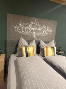 a bedroom with two beds with a large headboard at Deluxe Loft in Bad Kissingen