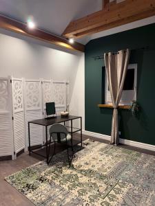 a room with a desk and a window and a table at Deluxe Loft in Bad Kissingen