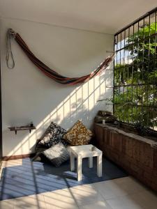 a room with a white table and a window at Arya Land Yoga Hostel in Cali