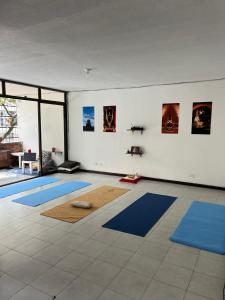 a room with blue mats on the floor at Arya Land Yoga Hostel in Cali