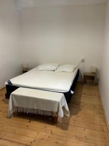 a bedroom with two beds and a wooden floor at Logement Sainte-Énimie in Sainte-Énimie