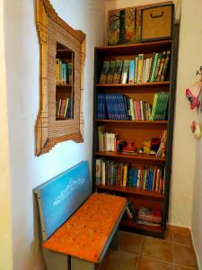 a bench sitting in front of a book shelf at B&B Meladormo in Tempio Pausania