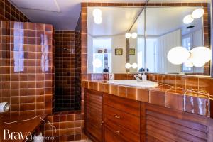 a bathroom with a sink and a mirror at Es Forn - Vistas panorámicas a la bahía I terraza privada I 5 dormitorios I chimenea I centro histórico I Brava Experience in Cadaqués