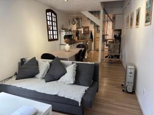 a living room with a couch and a dining room at Logement Sainte-Énimie in Sainte-Énimie