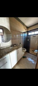 a bathroom with a sink and a toilet at Casa Marron in Anchieta
