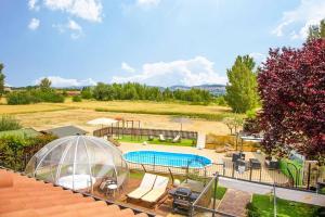 an image of a backyard with a pool and a domed greenhouse at VILLA PATTY ASSISI con SPA e Piscina in Assisi