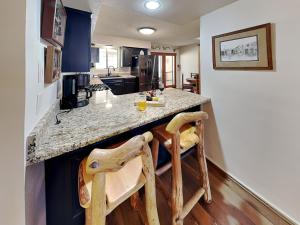 a kitchen with a large island with a counter top at Billy The Kid at Aspen Run 4A in Ruidoso
