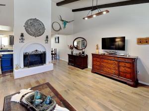 a large living room with a tv and a fireplace at Billy The Kid at Aspen Run 4A in Ruidoso