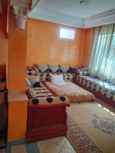 a bedroom with two beds and a window at chez l'habitant amazigh in Ouarzazate