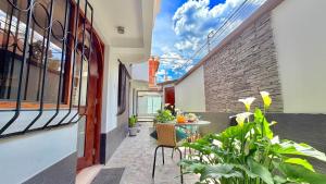 an outdoor patio with a table and chairs and plants at Allincay Cusco Apart Hotel in Cusco