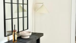 a bathroom with a black table with a vase on it at Bayab Charming Rooms - Corso Garibaldi in Benevento +50 photos