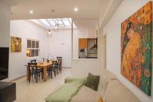 a living room with a couch and a dining room at El Laurel, Remote Work Friendly, City Center in Los Llanos de Aridane