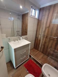 a bathroom with a shower and a sink and a toilet at il Mandarino in Bahía Blanca