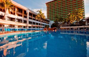 a large swimming pool in front of a hotel at El Cid Castilla Beach in Mazatlán